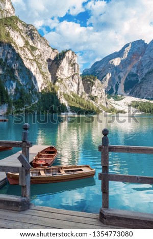 Lake Lago di Braies in Dolomiti mountains, South Tyrol, Italy. Dock with romantic old wooden rowing boats on lake. Amazing view of Lago di Braies (Braies lake, Pragser wildsee) in sunset light. Royalty-Free Stock Photo #1354773080
