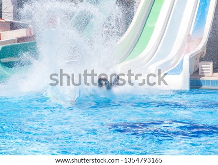 Colorful waterpark tubes, spray slides and pool in aquapark. Water park slides close up.