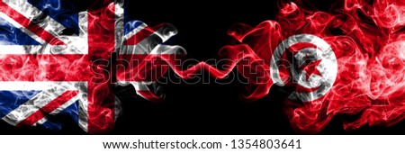 United Kingdom vs Tunisia, Tunisian smoky mystic flags placed side by side. Thick colored silky smoke flags of Great Britain and Tunisia, Tunisian. Royalty-Free Stock Photo #1354803641