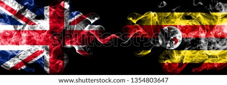 United Kingdom vs Uganda, Ugandan smoky mystic flags placed side by side. Thick colored silky smoke flags of Great Britain and Uganda, Ugandan.