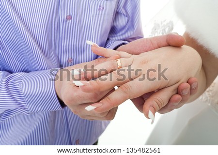 wedding rings in hand. Newly wed bride and groom holding hands rings.