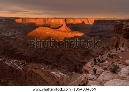 Collection of photographers prepare to take picture of sunrise of a canyon