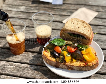 lunchtime, sandwiches with grilled vegetables. Lunch in the open air. Beer with food