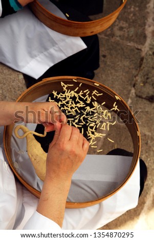 Handmade traditional pasta, called "fides", a typical product of many greek islands, usually made using kneading pasta and using a colander, as seen in the picture.
