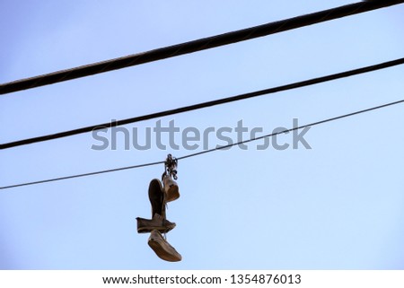 Old sneakers hanging from powerlines