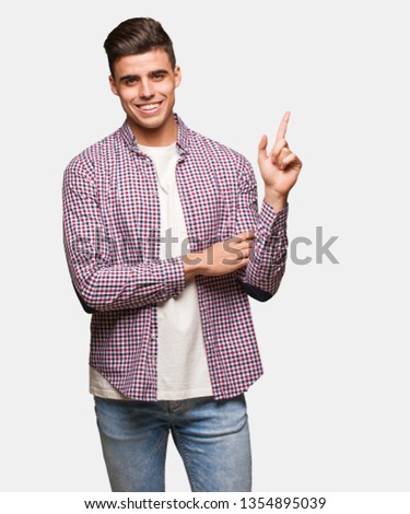 Young cool man pointing to the side with finger