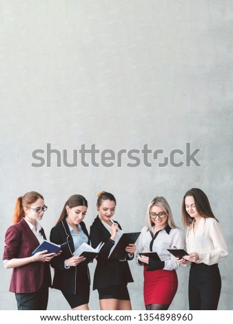 Women in business. Successful confident female team. Power knowledge and equal gender rights. Ladies holding planners and clipboards. Empty space