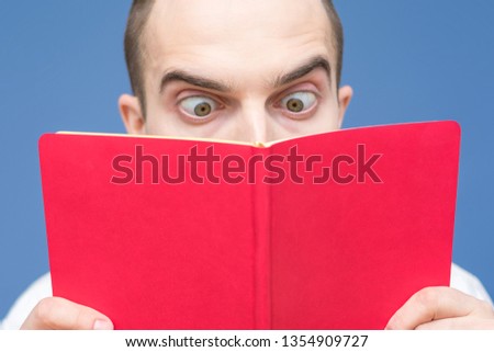 The guy intently reading a book, open book, close up, background, copy space, for advertising