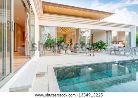 home or house Exterior design showing tropical pool villa with greenery garden Royalty-Free Stock Photo #1354913225