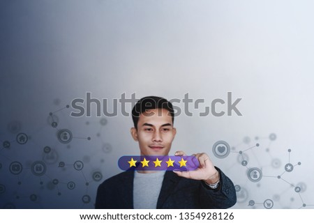 Customer Experience Concept. Young Businessman with Happy Face Showing Five Star Services Rating Satisfaction on Card. Happy Client's Feedback and Online Review. Surrounded by Network Icons