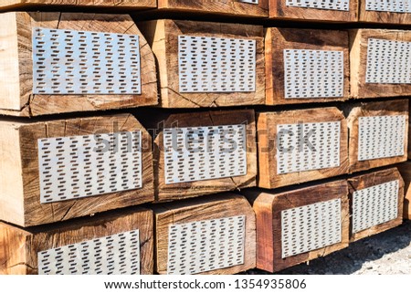 stacked of new wooden railway sleepers
