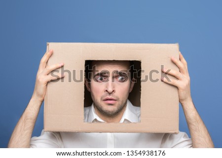 Sad male with box on head, front view