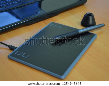 Graphic tablet and pen on the table