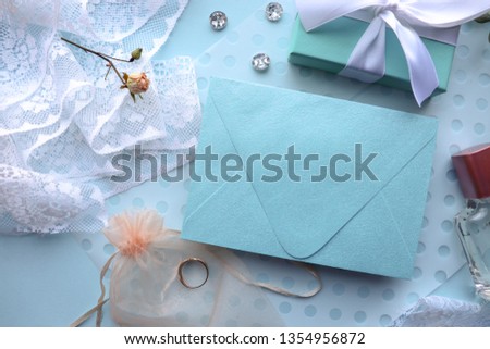 wedding card design. white lace, flowers, wedding ring, perfume bottle and envelope