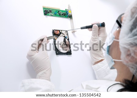 Technical surgeon working on hard drive - data recovery