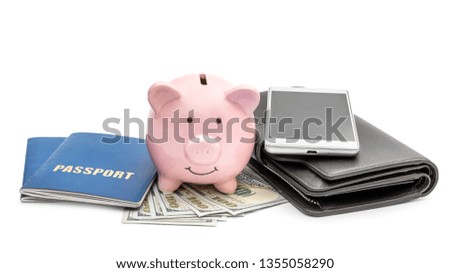 Piggy bank with money, passports, wallet and smartphone on white. Savings for vacation.