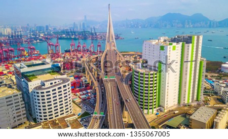 Aerial bird eye view Photography viewpoint traffic Container Cargo freight ship with working crane bridge in shipyard under Stonecutters highway bridge for Logistic Import Export, Hong Kong