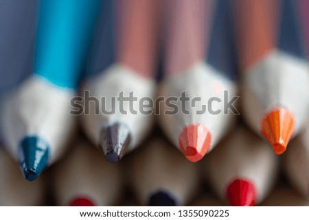 The sharp tips of the colored pencils with selective focus. Beautiful colored pencils tips background. Beautiful colored pencils tips creative concept for copy space ideal for banner or text over lay.