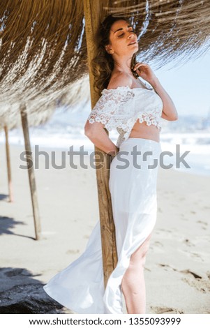 Attractive woman on the beach umbrella