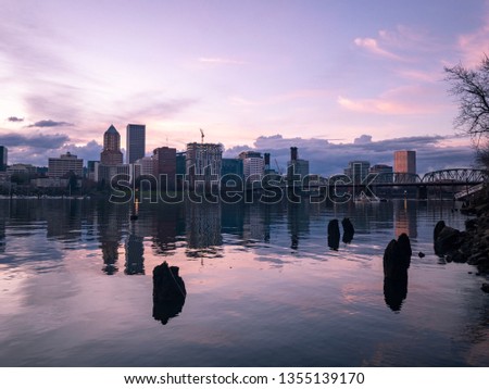 Panorama of downtown Portland, Oregon. Photo taken at sunset with dramatic clouds and reflections on the Willamette River
