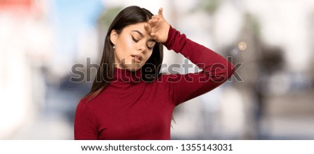 Teenager girl with turtleneck with tired and sick expression at outdoors