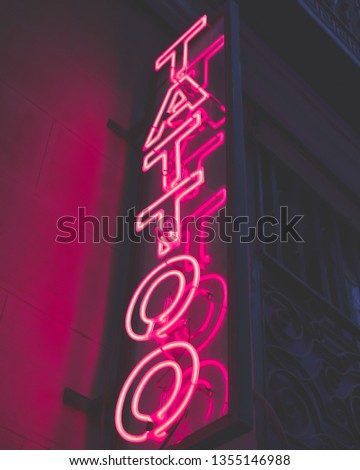 neon tattoo magenta color sign on street