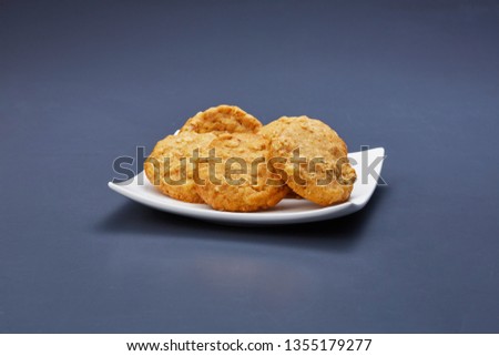 Delicious cookies on a modern plate in the middle of gray mid tone background.