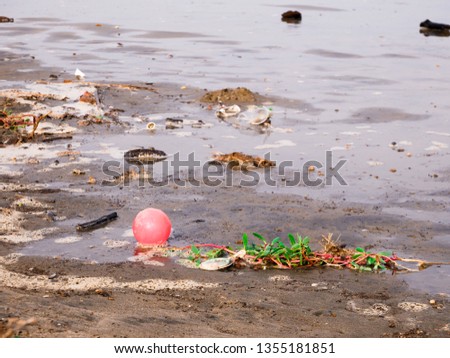 a plastic ball floating on the shore of a caribbean beach near cartagena colombia contamination pollution