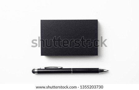 Design concept - top view of black business card with ball point pen isolated on white background for mockup, it's real photo, not 3D render