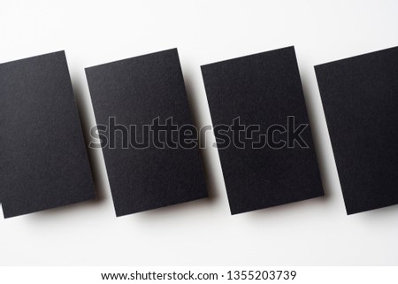 Design concept - top view of 4 black business card isolated on white background for mockup, it's real photo, not 3D render