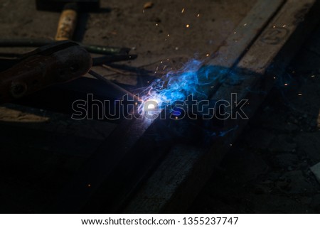Hand hold welding steel. Renovation wooden house to new construction. Welds with argon-arc welding.