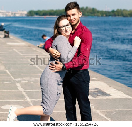  Happy young couple in love. Guy hugging a girl. Romantic relationship.