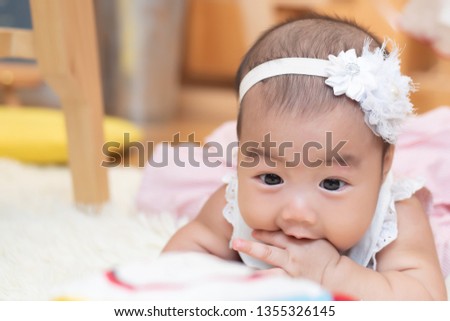happy infant baby girl crawling, playing with educational toy