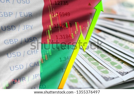 Madagascar flag and chart growing US dollar position with a fan of dollar bills