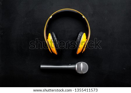 blogger, journalist or musician office desk with microphone and headphones on black background top view