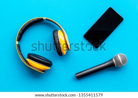 podcast record with phone, microphone and headphones on blue background top view space for text