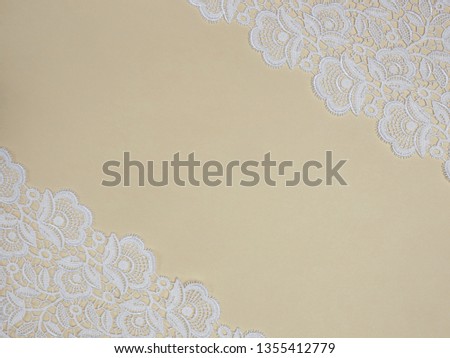 White lace on a beige background