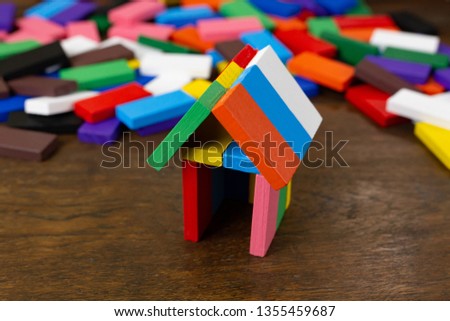 Domino multi color build home on wood table image.