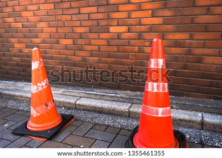 Old traffic three cones on brick wall texture grunge background