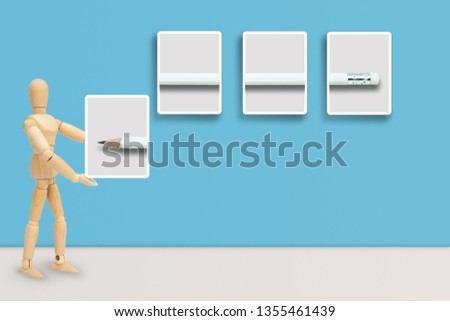 Business Idea Concept : Wooden figure mannequin hang white pencil in picture frame on blue wall.