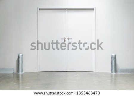 Double doors with security lock  in warehouse close up. Royalty-Free Stock Photo #1355463470
