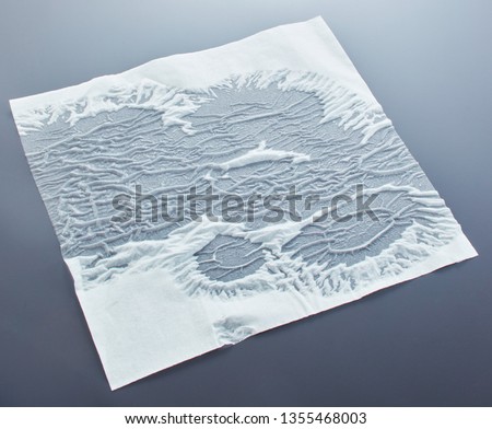Partially wet tissue on a reflective dark background. Wet tissue texture for 3D use.