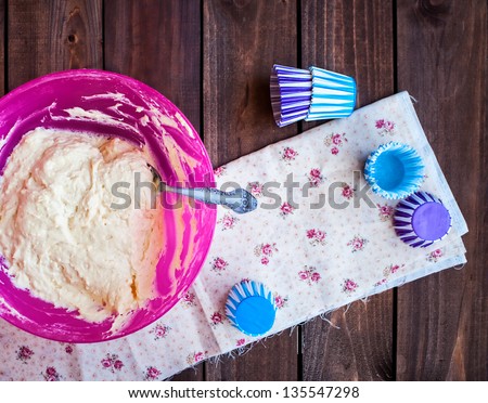pastry for cheese muffins on the dark wood background