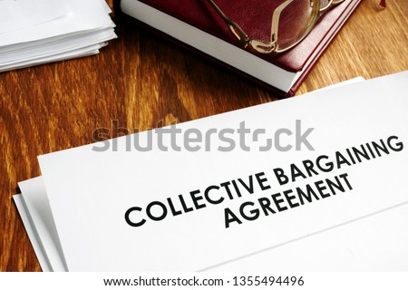 Collective bargaining agreement and note pad with glasses. Royalty-Free Stock Photo #1355494496