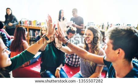 Diverse students giving high five to team Royalty-Free Stock Photo #1355507282