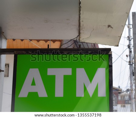 ATM outside the market. People in Queues to withdraw cash. ATM sign board