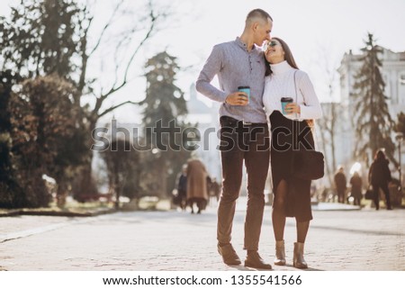 Lovely young couple walking at old city town, smiling, kissing, drinking coffee and have fun together