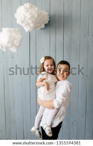 Two Caucasian siblings brother and sister posing for picture during family photo shooting