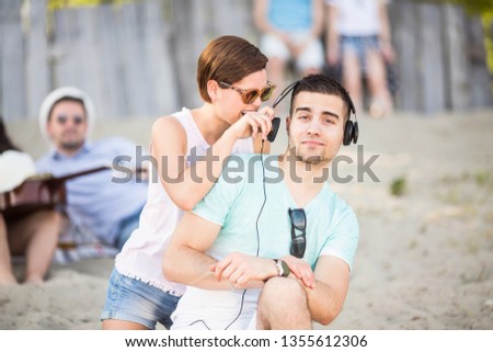 Young happy couple with a friends at the beach 
