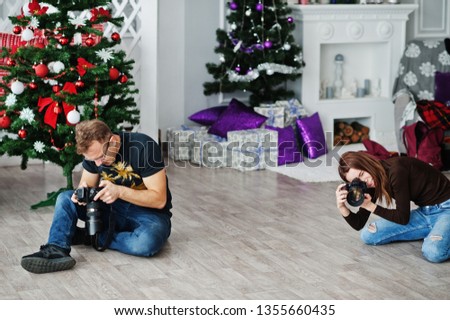 The team of two photographers shooting on studio. Professional photographer on work.